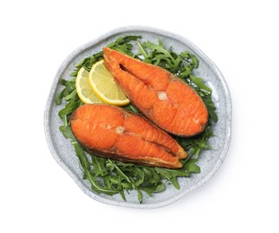 Photo of Seafood. Tasty salmon steaks, arugula and lemon isolated on white, top view