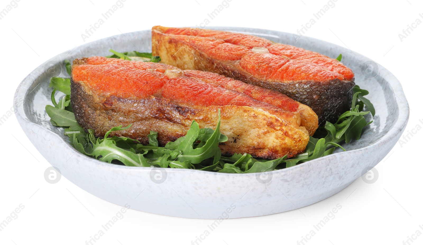 Seafood. Tasty salmon steaks and arugula isolated on white Photo of Seafood. Tasty salmon steaks and arugula isolated on white