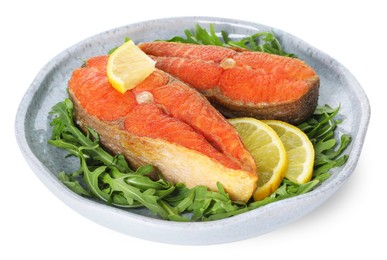 Photo of Seafood. Tasty salmon steaks, arugula and lemon isolated on white