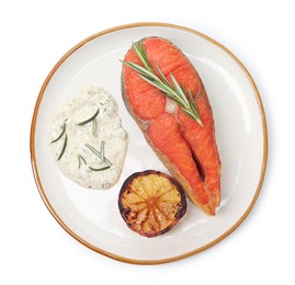 Photo of Seafood. Tasty salmon steak, sauce, lemon and rosemary isolated on white, top view