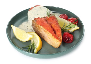 Photo of Seafood. Tasty salmon steak, sauce, tomatoes, rosemary and lemon isolated on white