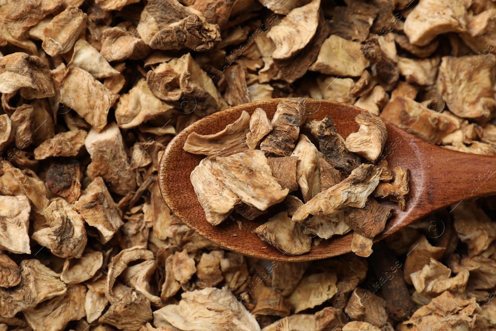 Pieces of dry chicory roots and spoon as background, closeup Photo of Pieces of dry chicory roots and spoon as background, closeup