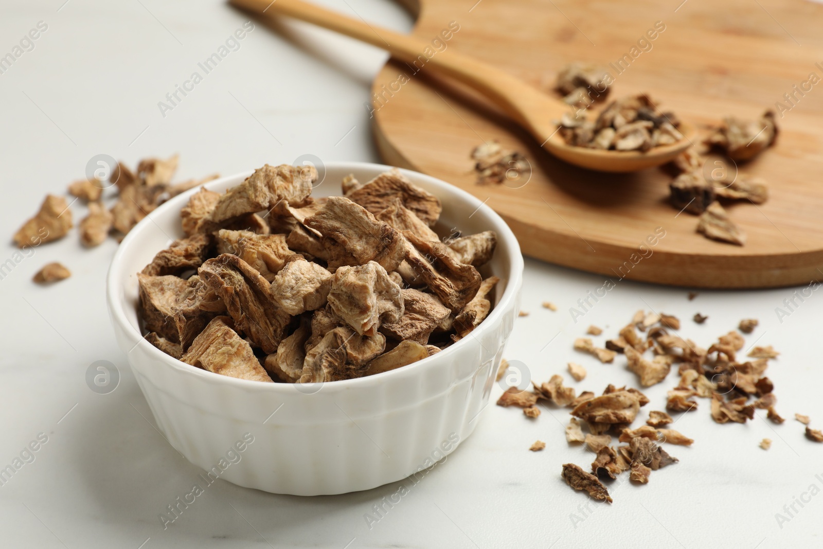 Pieces of dry chicory roots on white table, closeup Photo of Pieces of dry chicory roots on white table, closeup