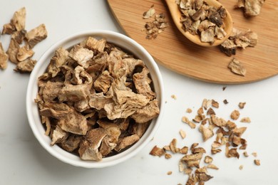 Photo of Pieces of dry chicory roots on white table, flat lay