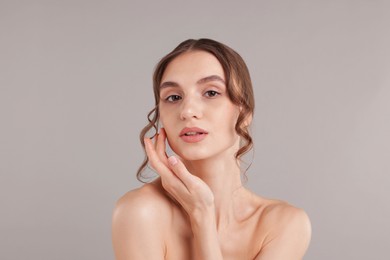 Photo of Portrait of attractive young woman on light grey background