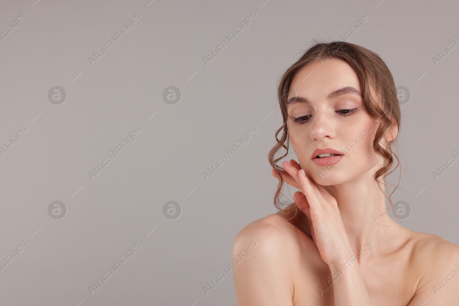 Portrait of attractive young woman on light grey background. Space for text Photo of Portrait of attractive young woman on light grey background. Space for text