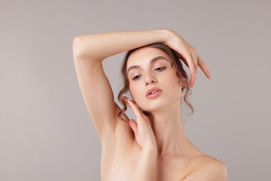 Photo of Portrait of attractive young woman on light grey background