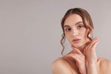 Photo of Portrait of attractive young woman on light grey background. Space for text