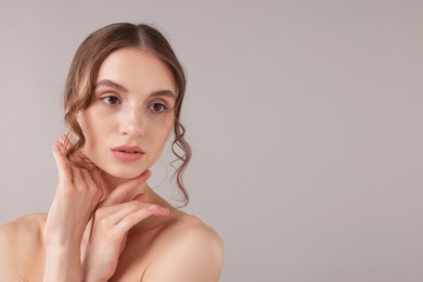 Photo of Portrait of attractive young woman on light grey background. Space for text