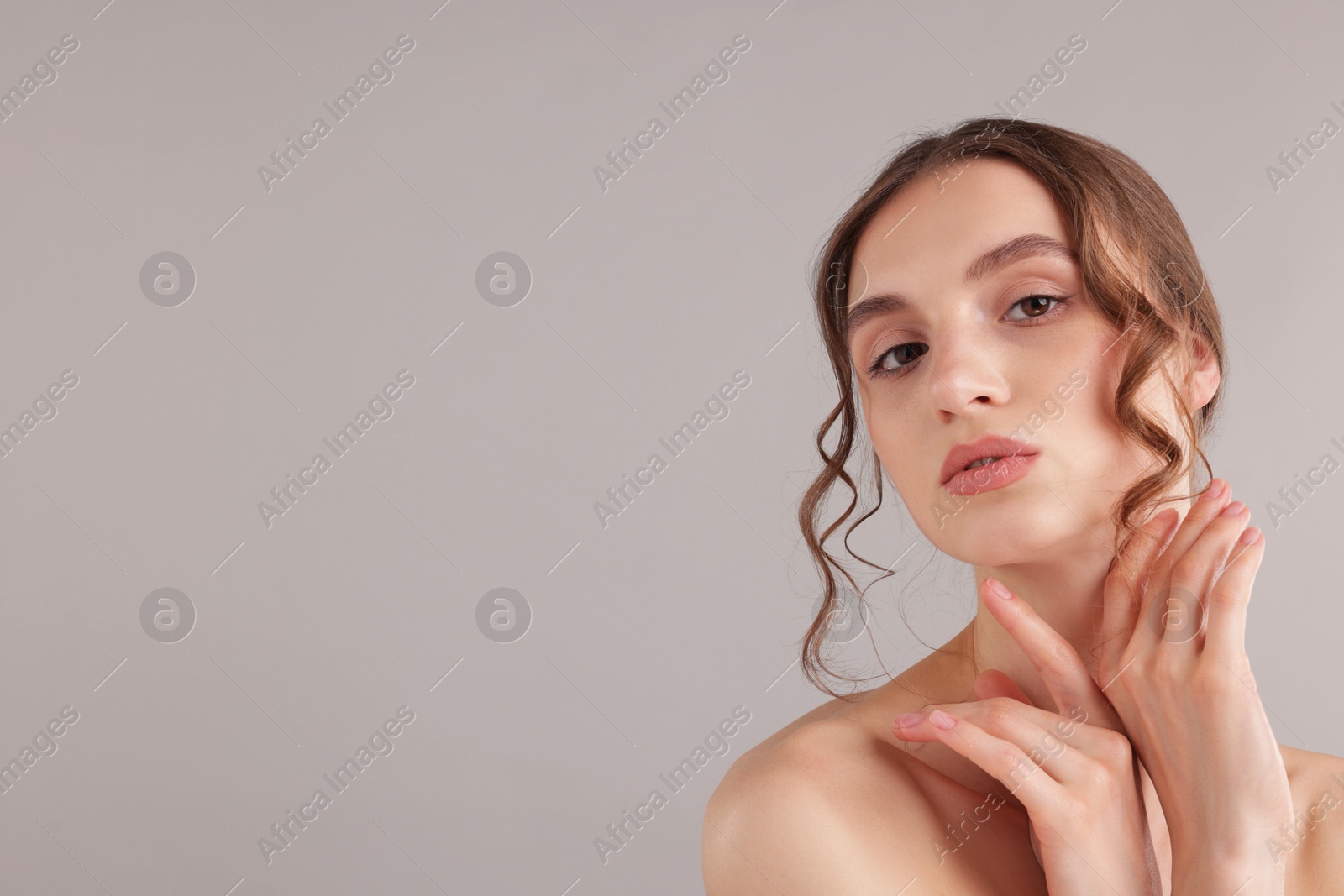 Portrait of attractive young woman on light grey background. Space for text Photo of Portrait of attractive young woman on light grey background. Space for text
