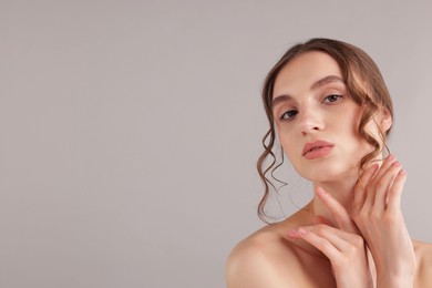 Photo of Portrait of attractive young woman on light grey background. Space for text
