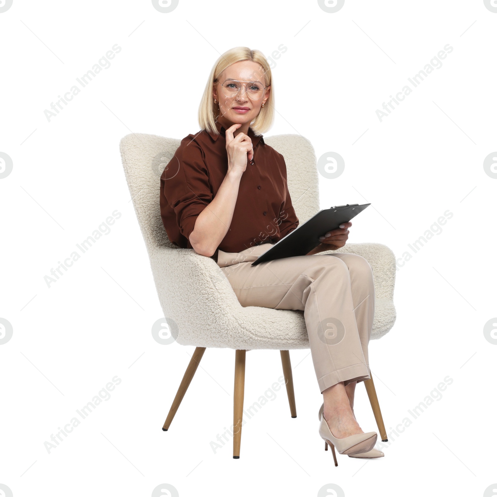 Professional psychologist with clipboard in armchair on white background Photo of Professional psychologist with clipboard in armchair on white background