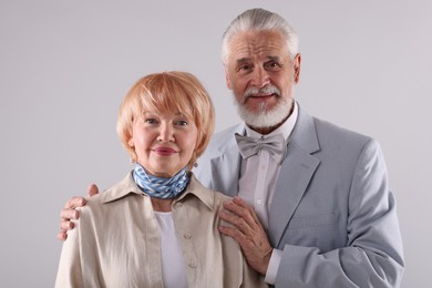 Photo of Lovely senior couple together on light grey background