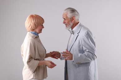 Photo of Lovely senior couple together on light grey background