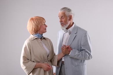Photo of Lovely senior couple together on light grey background