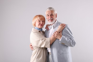 Photo of Lovely senior couple together on light grey background, space for text