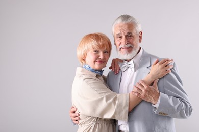Photo of Lovely senior couple together on light grey background, space for text