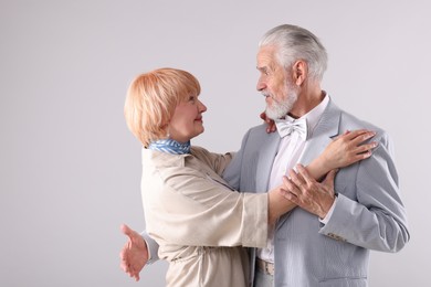 Photo of Lovely senior couple together on light grey background