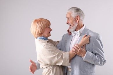 Photo of Lovely senior couple together on light grey background