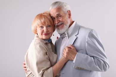 Photo of Lovely senior couple together on light grey background