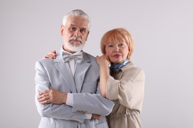 Photo of Lovely senior couple together on light grey background