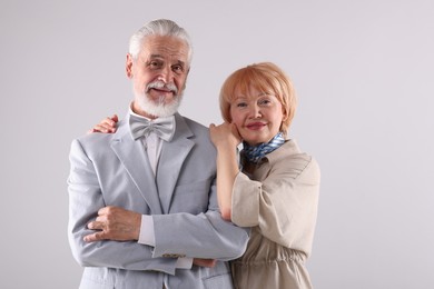 Photo of Lovely senior couple together on light grey background