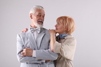 Photo of Lovely senior couple together on light grey background