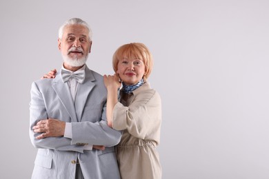 Photo of Lovely senior couple together on light grey background, space for text