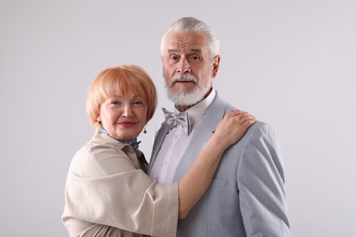 Photo of Lovely senior couple together on light grey background