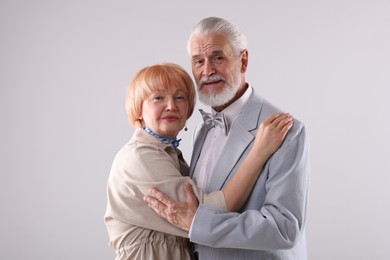 Photo of Lovely senior couple together on light grey background