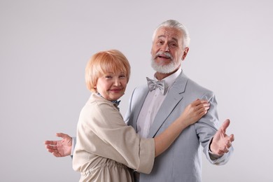 Photo of Lovely senior couple together on light grey background