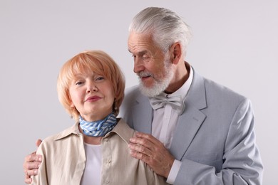 Photo of Lovely senior couple together on light grey background