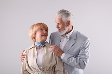 Photo of Lovely senior couple together on light grey background