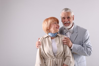 Photo of Lovely senior couple together on light grey background, space for text