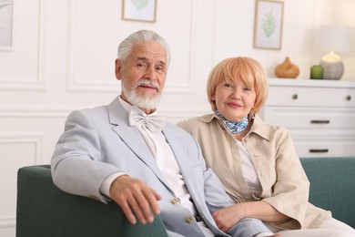 Photo of Lovely senior couple together on sofa at home