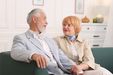 Photo of Lovely senior couple together on sofa at home