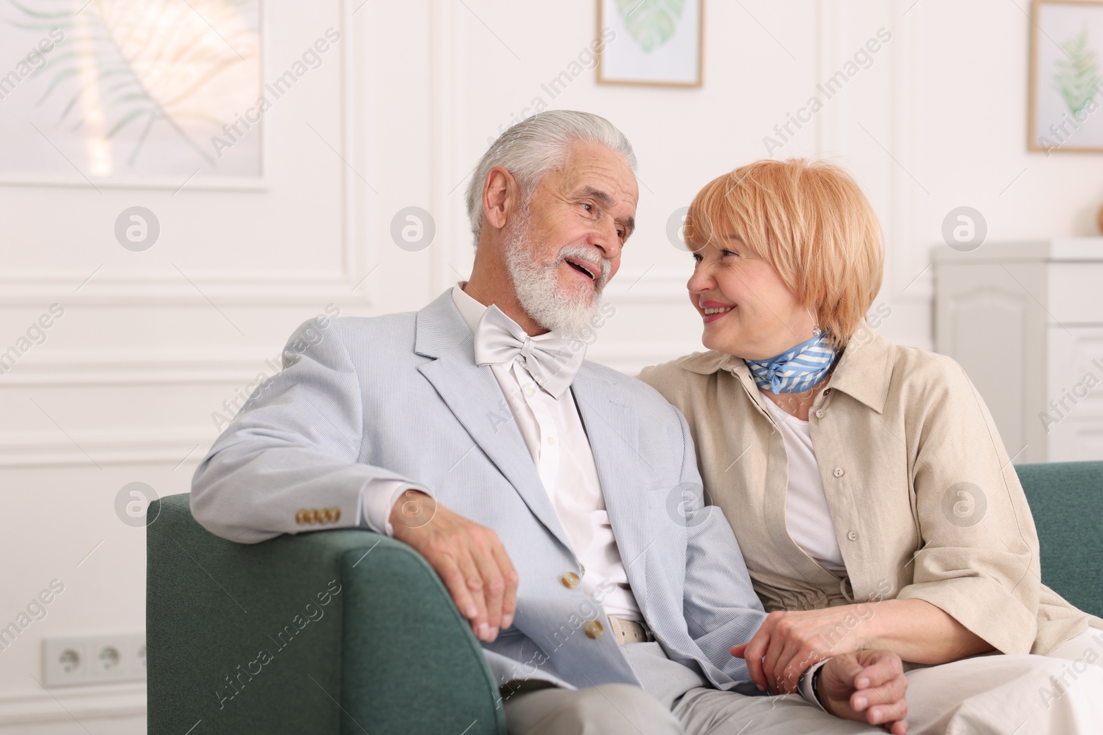 Lovely senior couple together on sofa at home Photo of Lovely senior couple together on sofa at home