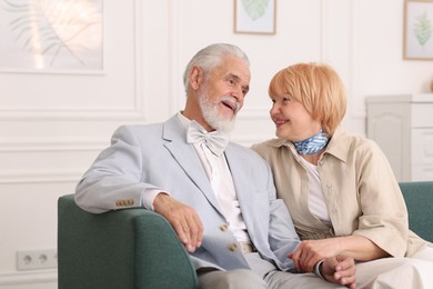 Photo of Lovely senior couple together on sofa at home