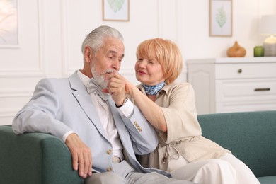 Photo of Lovely senior couple together on sofa at home
