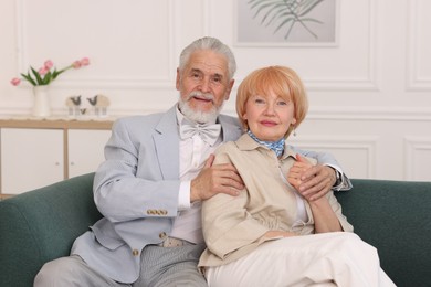 Photo of Lovely senior couple together on sofa at home