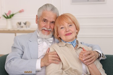 Photo of Lovely senior couple together on sofa at home