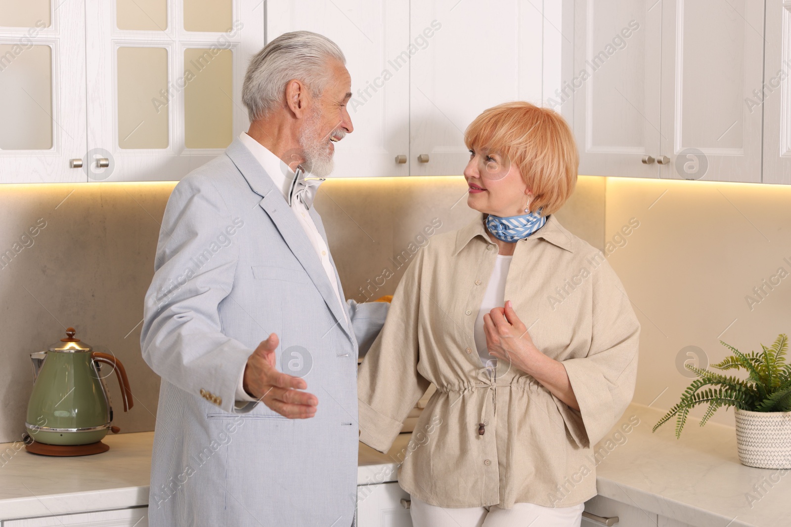 Lovely senior couple together in kitchen at home Photo of Lovely senior couple together in kitchen at home