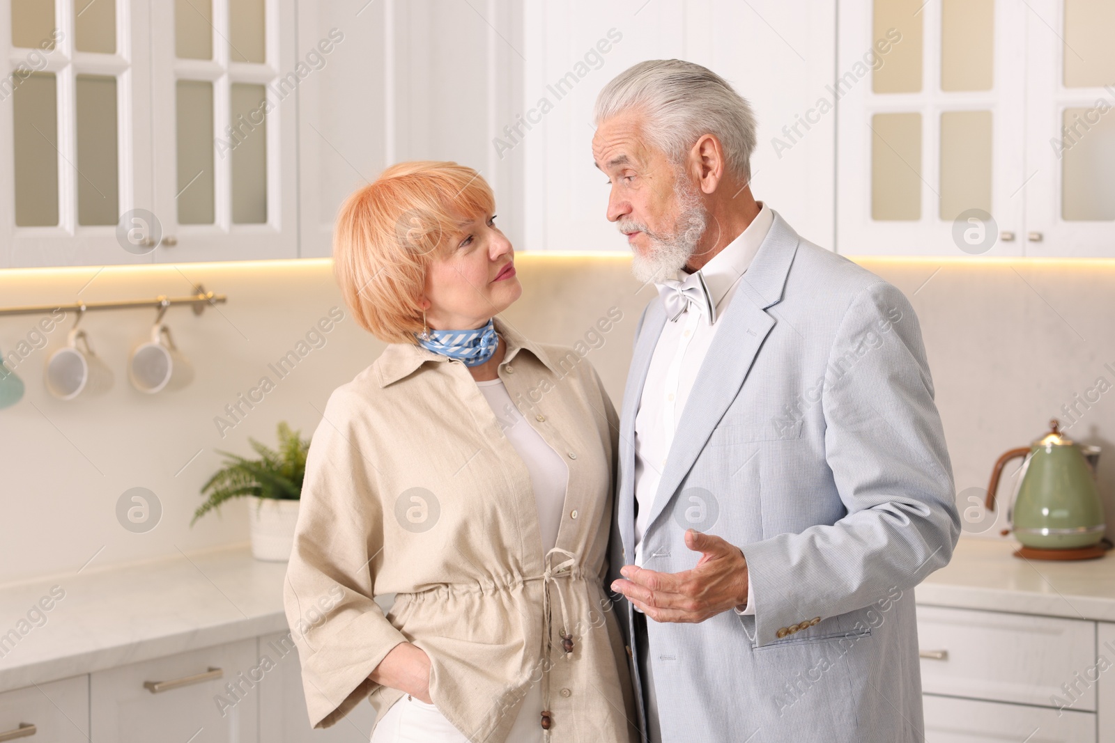 Lovely senior couple together in kitchen at home Photo of Lovely senior couple together in kitchen at home