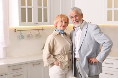Photo of Lovely senior couple together in kitchen at home, space for text