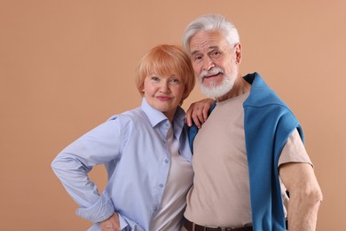 Photo of Lovely senior couple together on light brown background