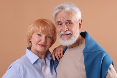Photo of Lovely senior couple together on light brown background