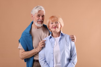 Photo of Lovely senior couple together on light brown background