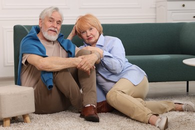 Photo of Lovely senior couple together on floor at home