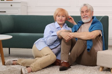 Photo of Lovely senior couple together on floor at home