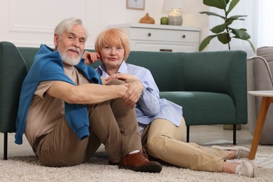 Photo of Lovely senior couple together on floor at home